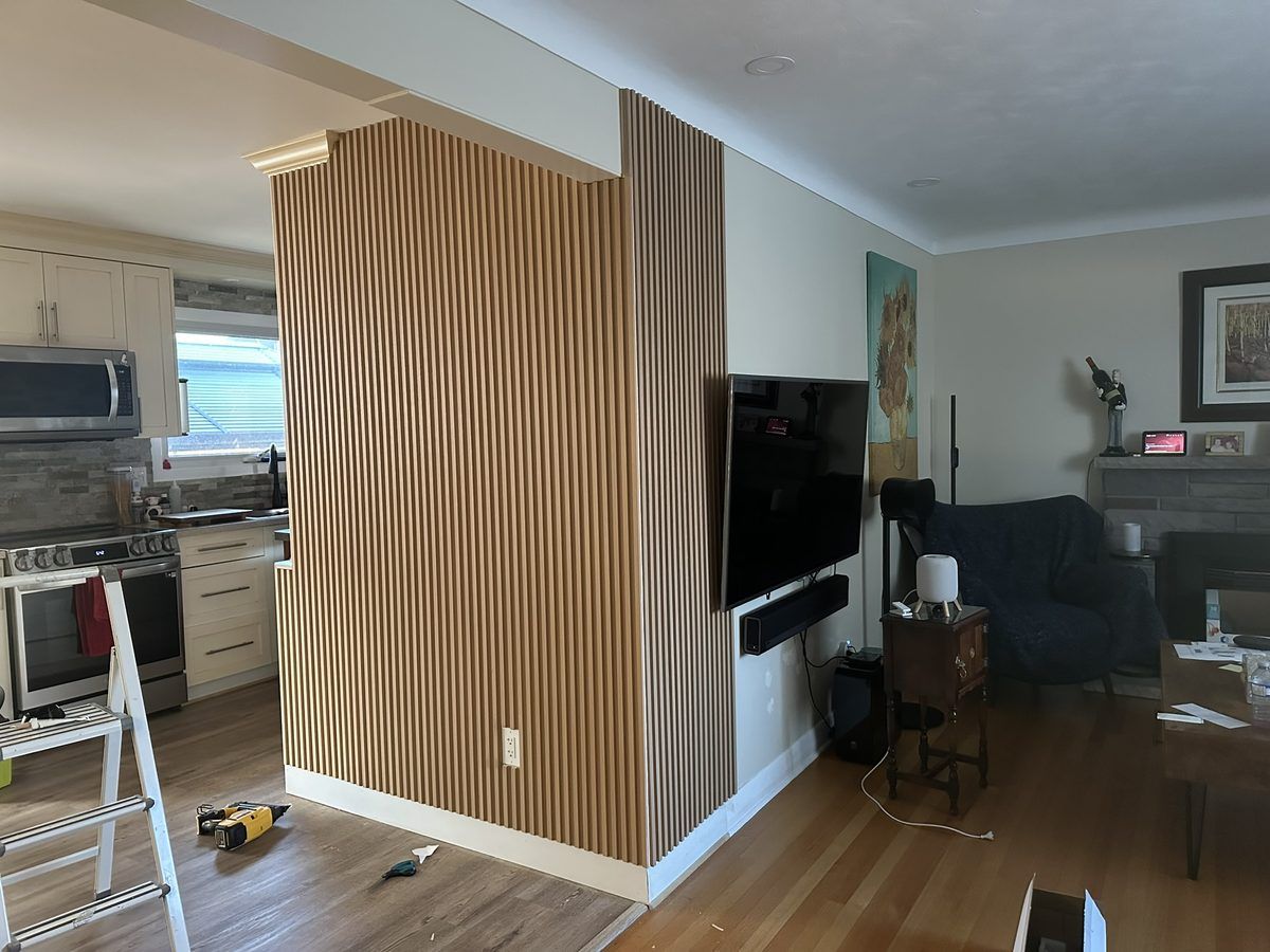 Living room with finished vertical slat wood feature wall